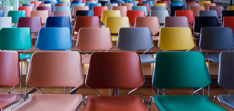 Rows of colorful empty chairs in Auditorium